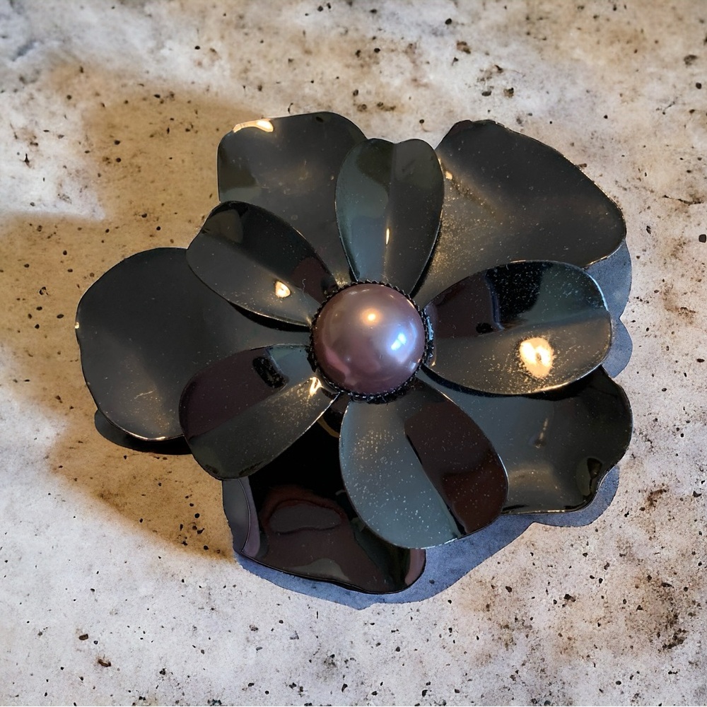Cuff bracelet with hematite tone and a purple faux mabe pearl accent.